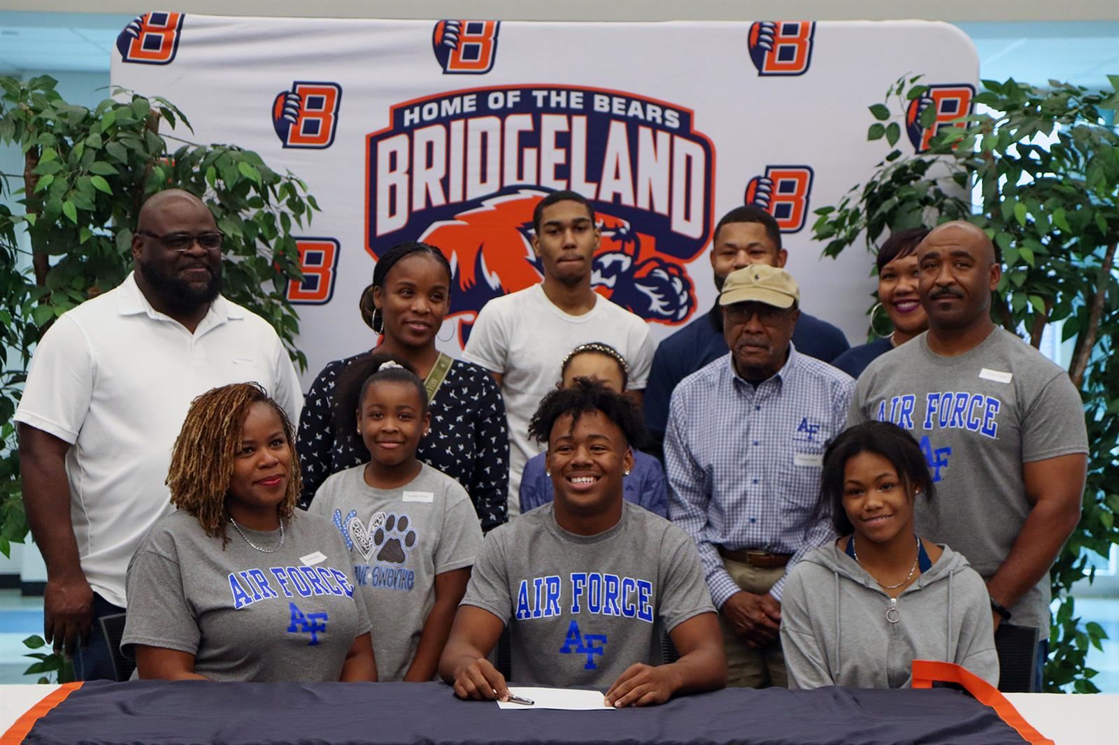 Bridgeland High School senior Terrance Cullivan, seated center, poses with his family after he signed his letter of intent.
